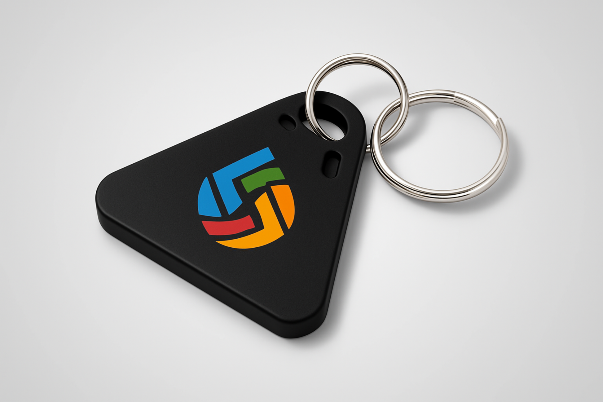 A photo of a triangular key fob with colorful print