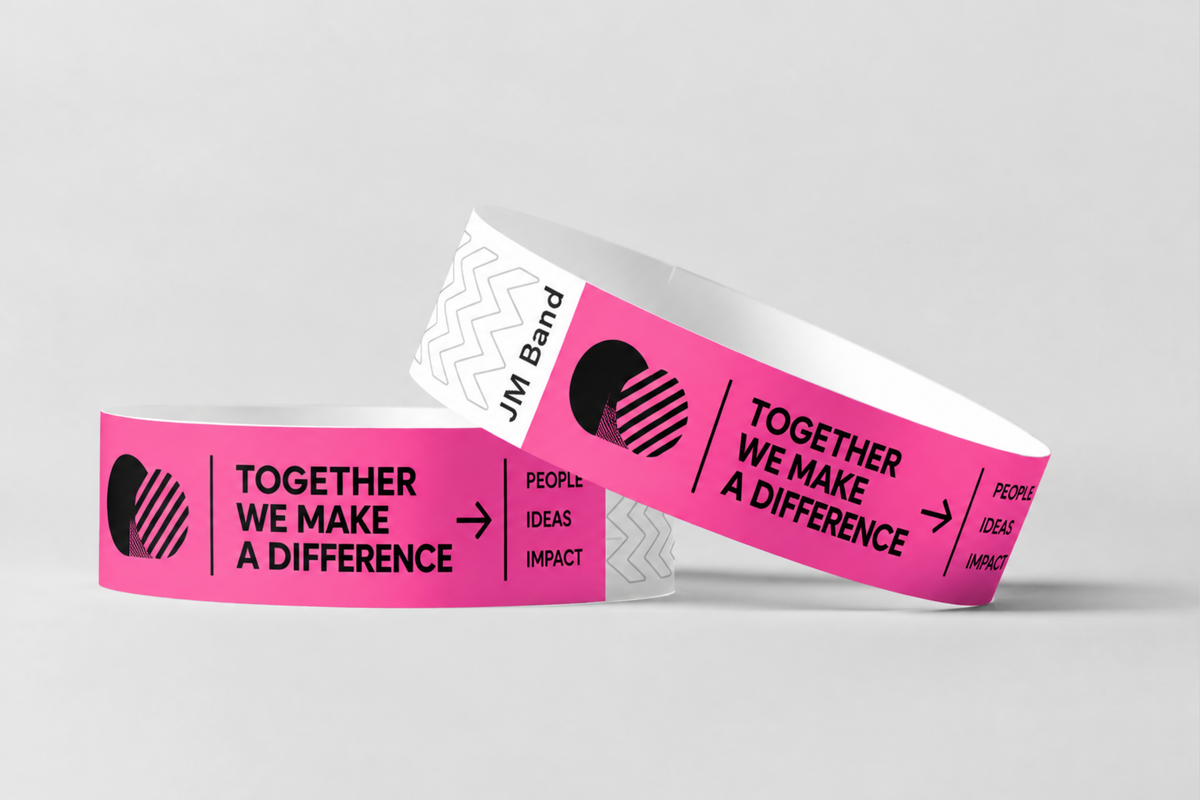 Two pink paper wristbands with black printed event text